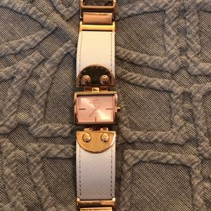 Micheal Kors rose gold and white watch.